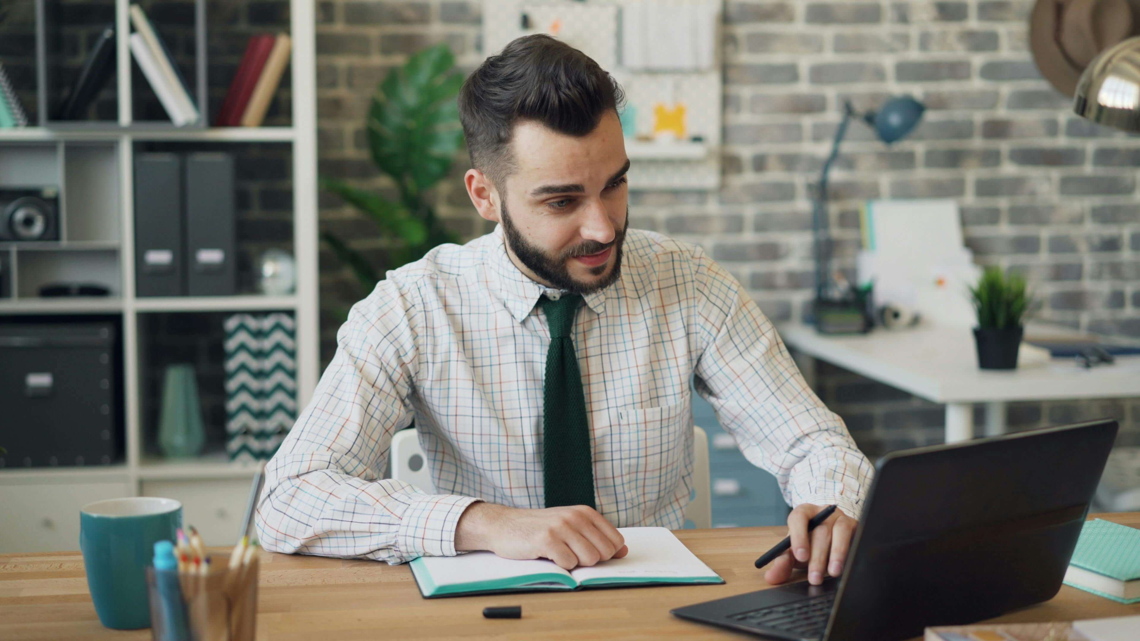 A Man Using a Laptop in a office