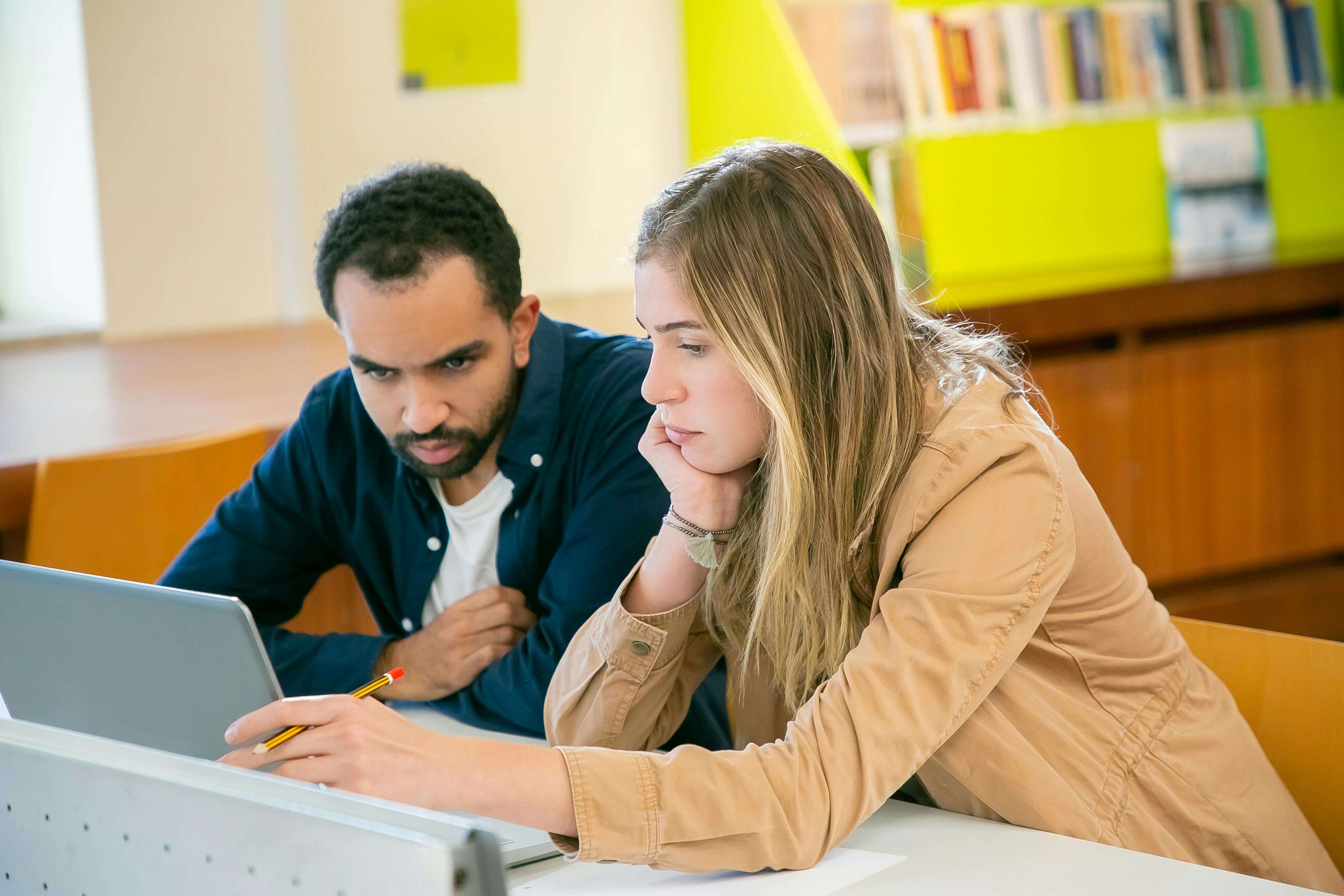 two students working together in library