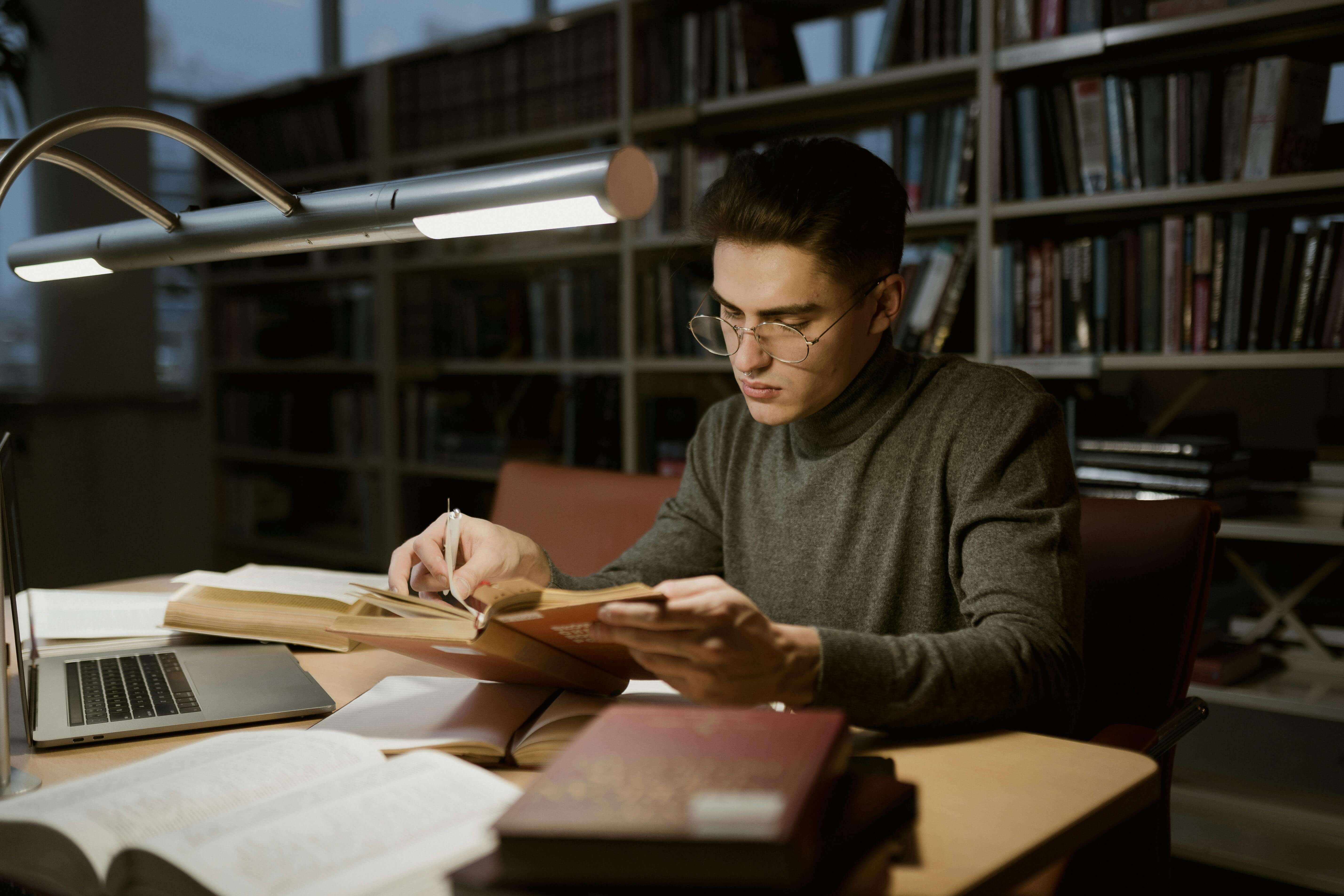 A Man Reading a Book in a Library