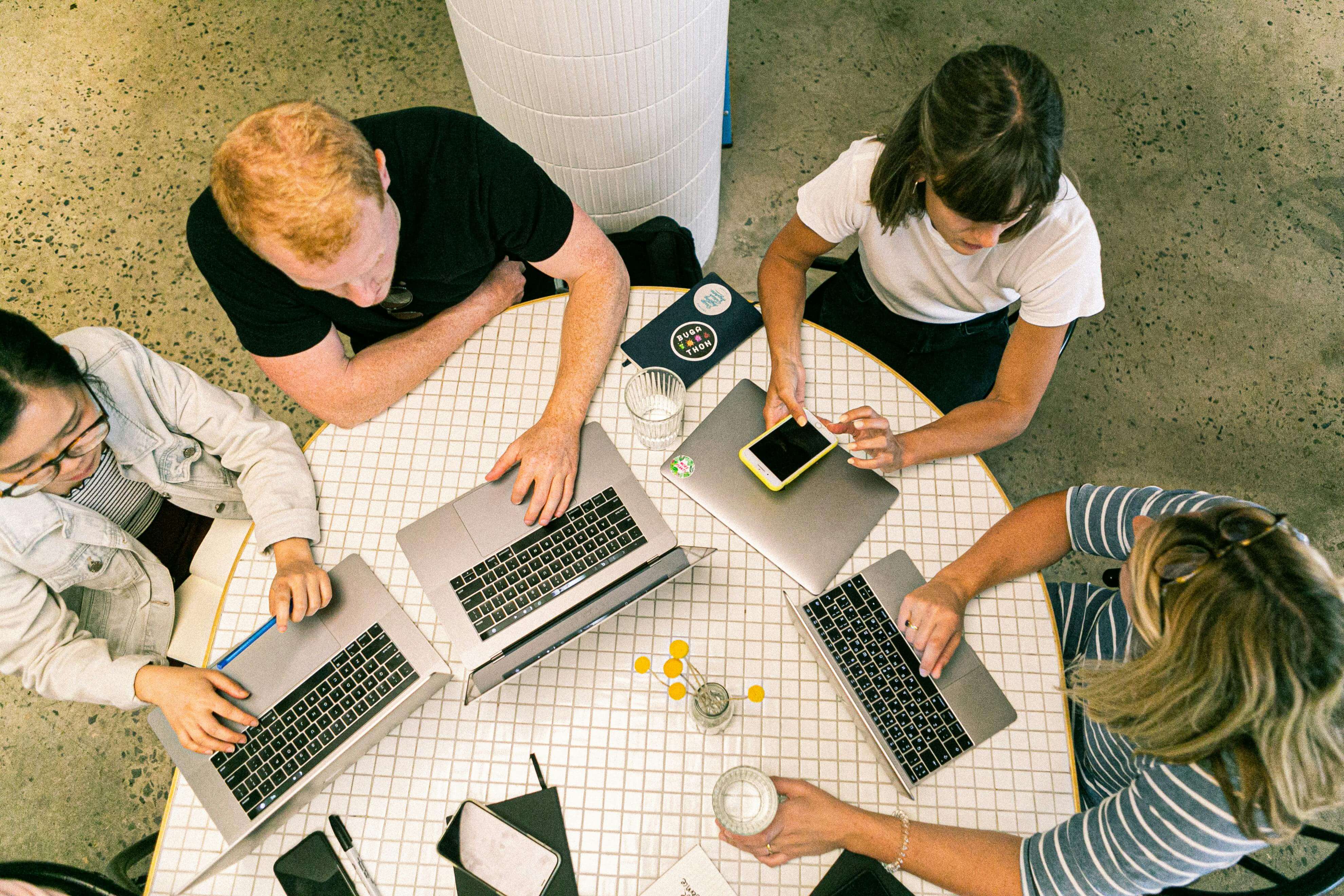 Four People Using Laptop Computers