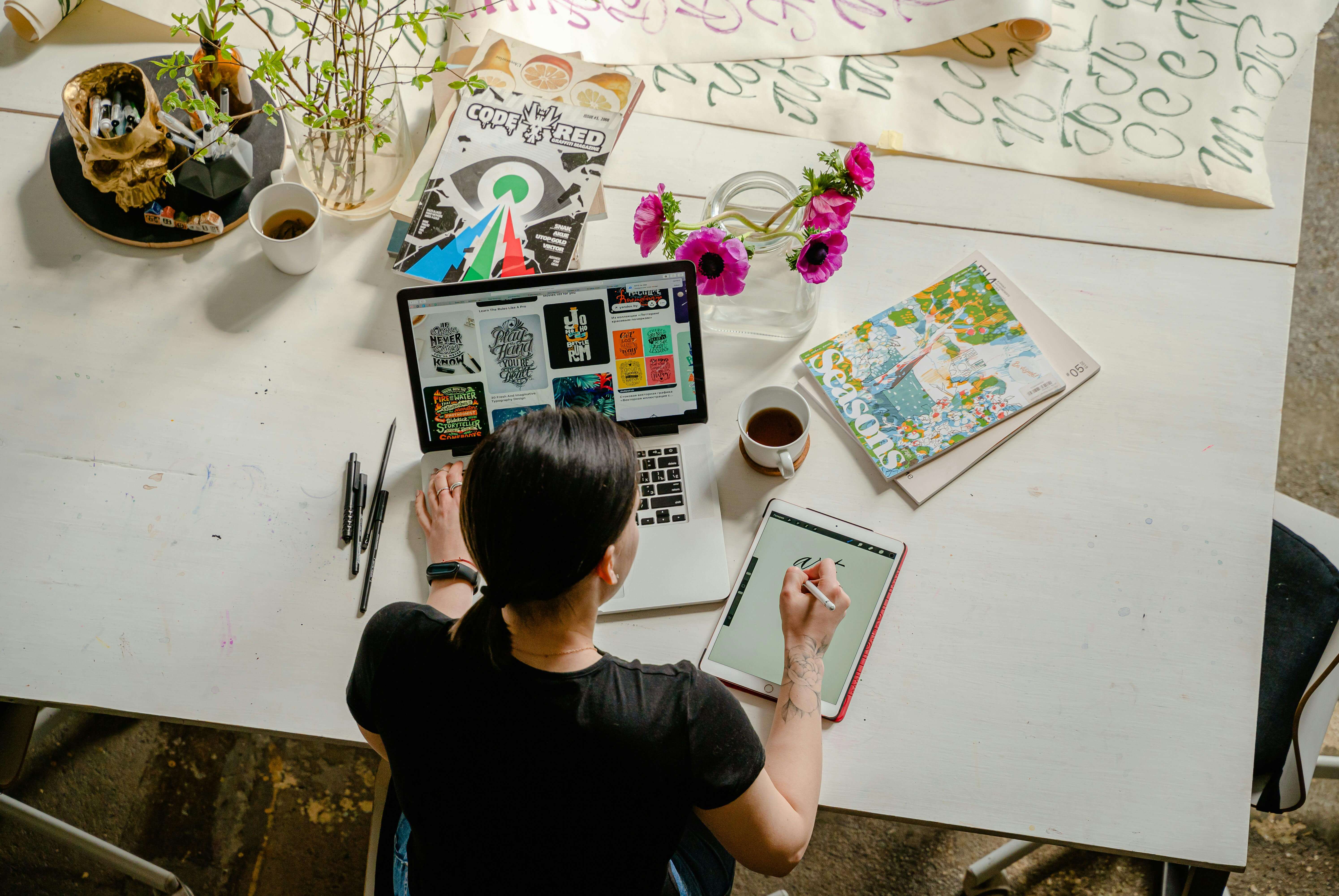 Photo of Woman Writing on Tablet