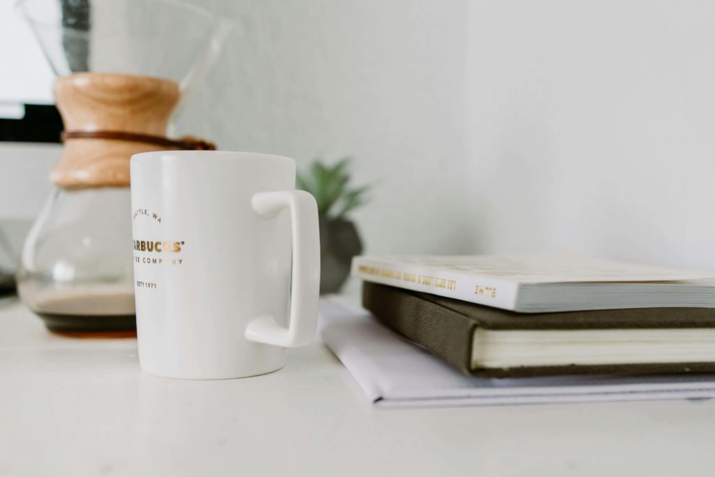 White Mug Near Book