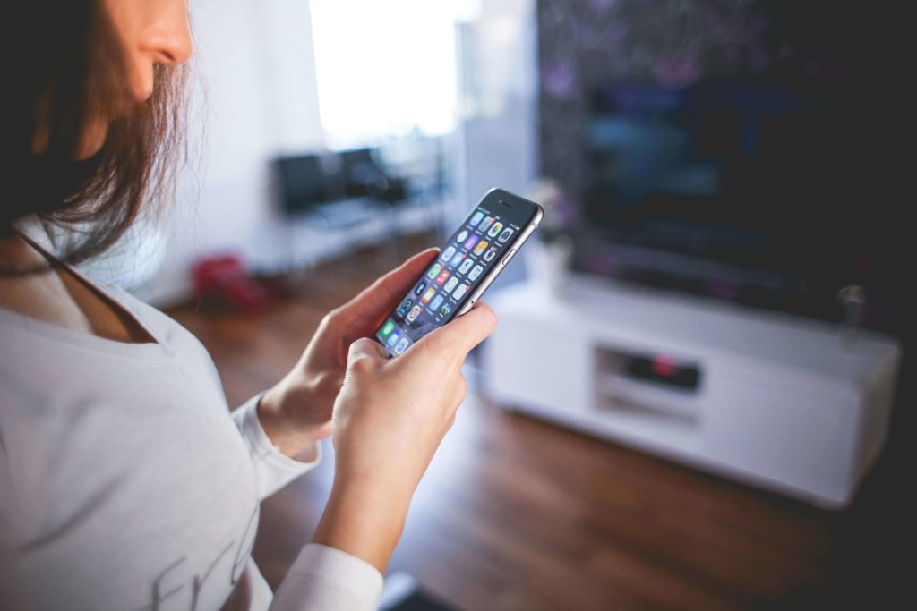 Woman Wearing White using her phone