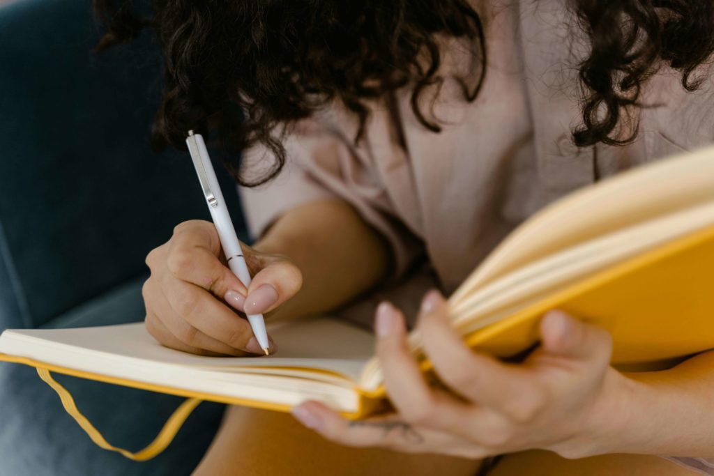 Woman Writing on White Paper