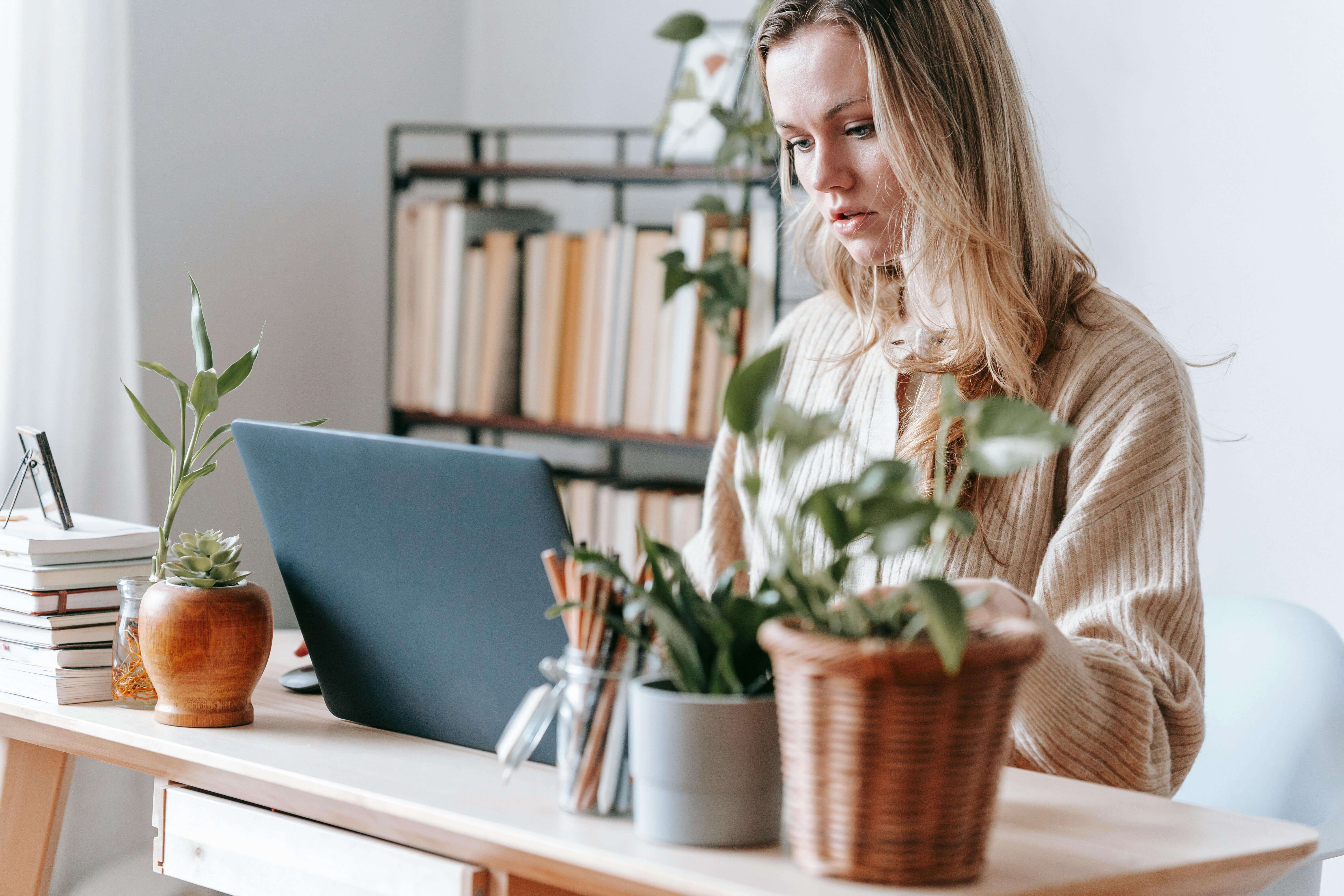 freelancer working on laptop at home desk