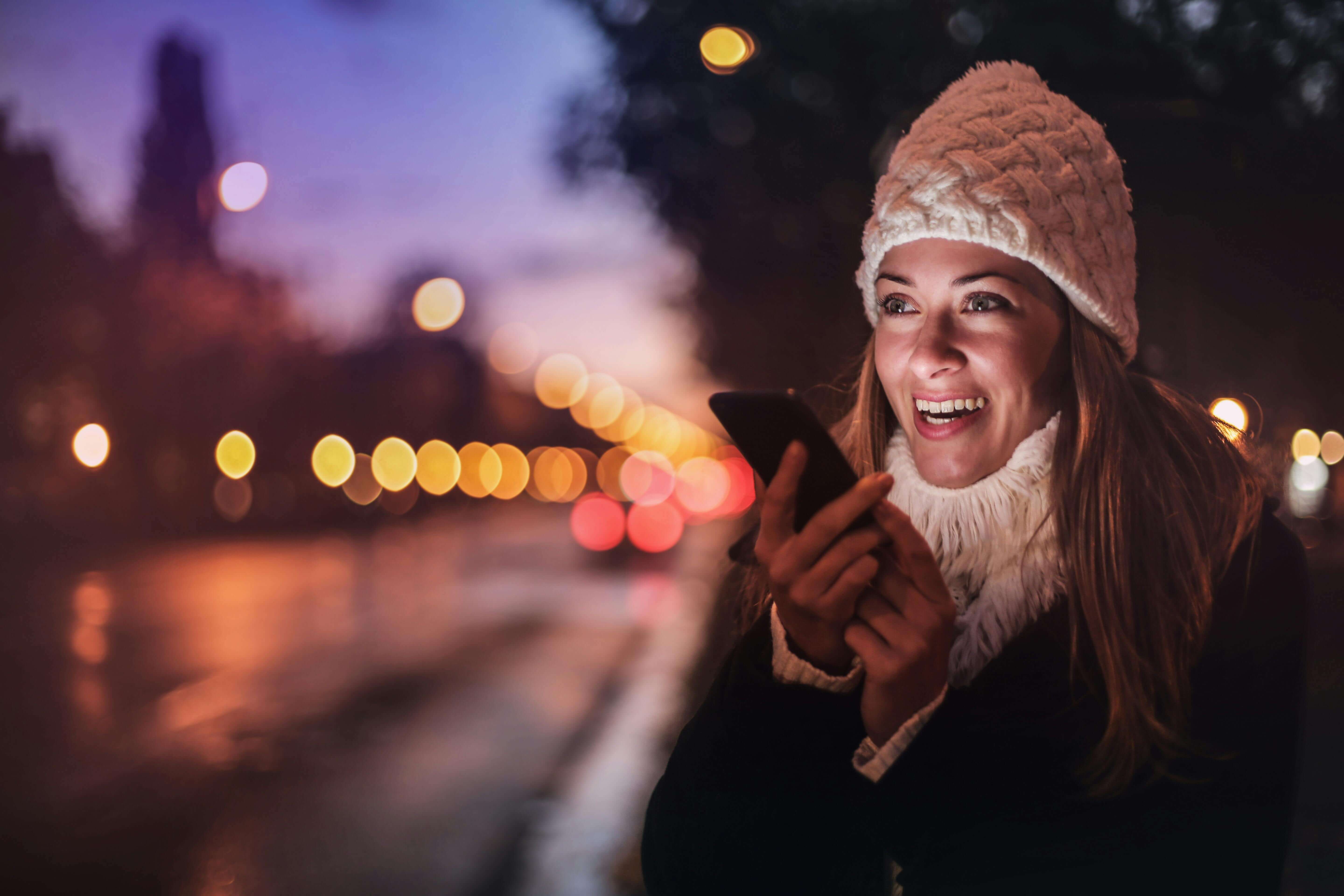 woman recording voice message on smartphone